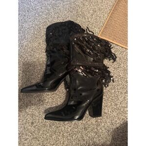 Black patent leather high heel boots with sequined fringe—bold, shiny